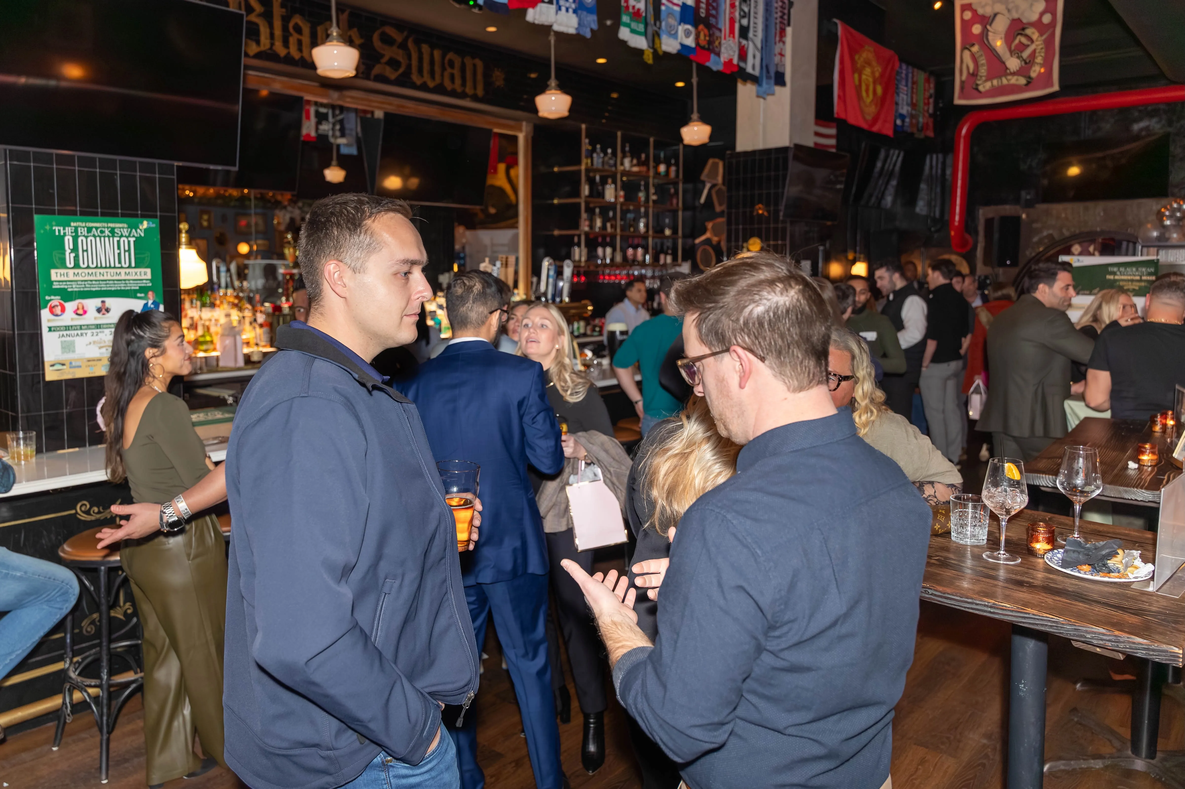 Attendees smiling for a photo at the networking bar
